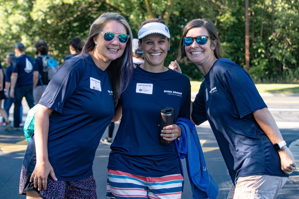 3 GVSU alumnae pose and smile towards camera